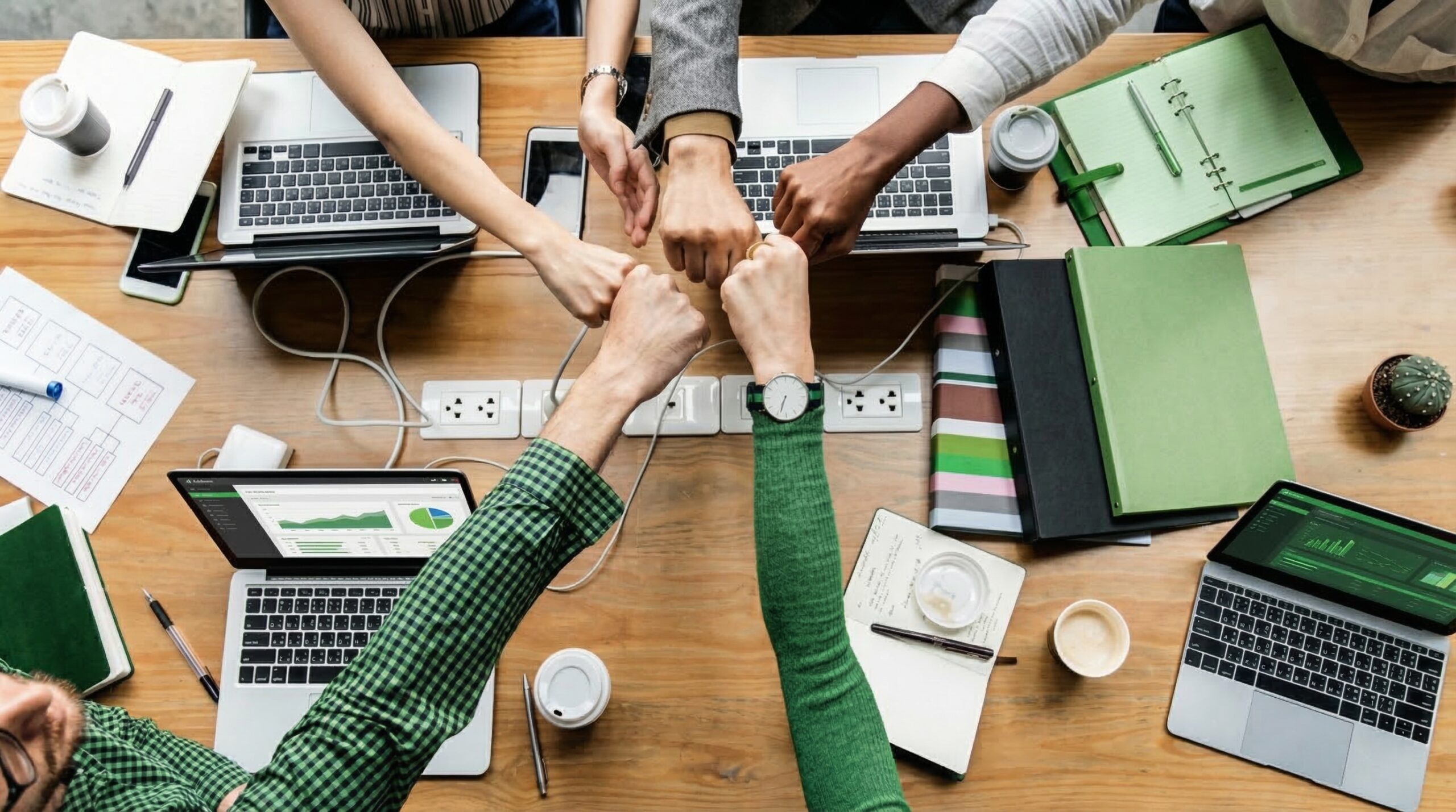 A group of people putting their fists together
